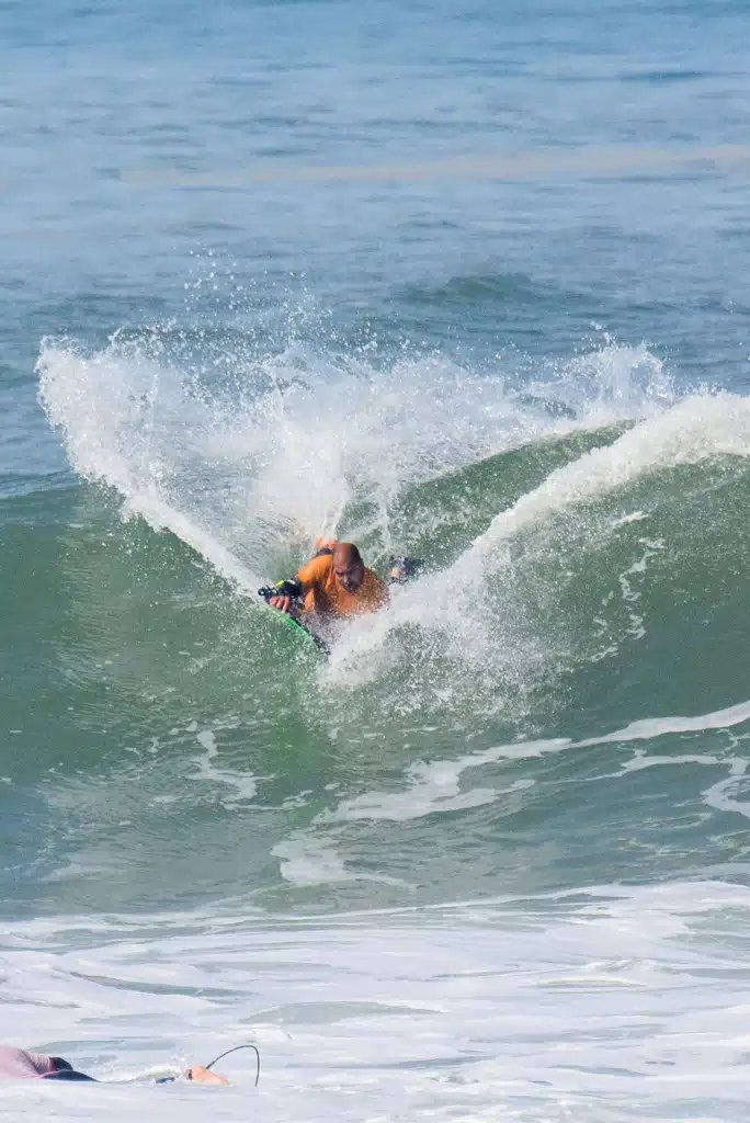 Sea Krew bodyboard coach guiding a student in the water in Ericeira