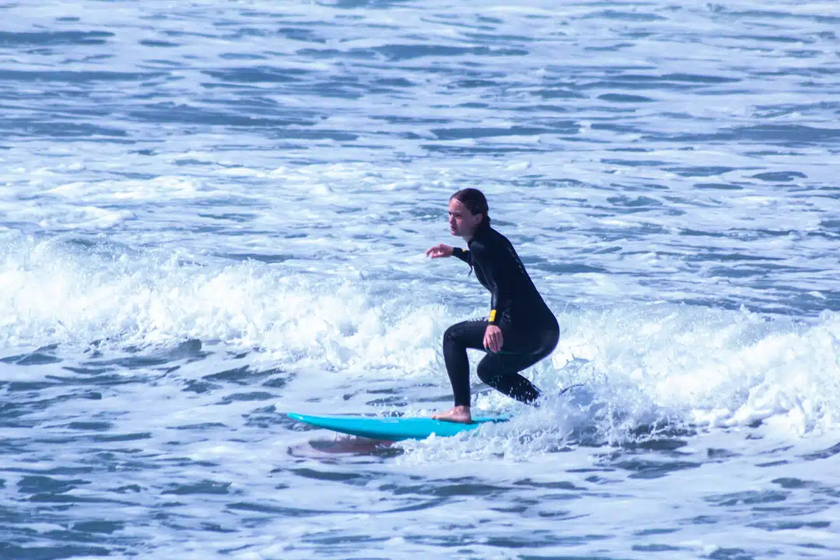 Student riding a wave during Sea Krew surf coaching session Ericeira