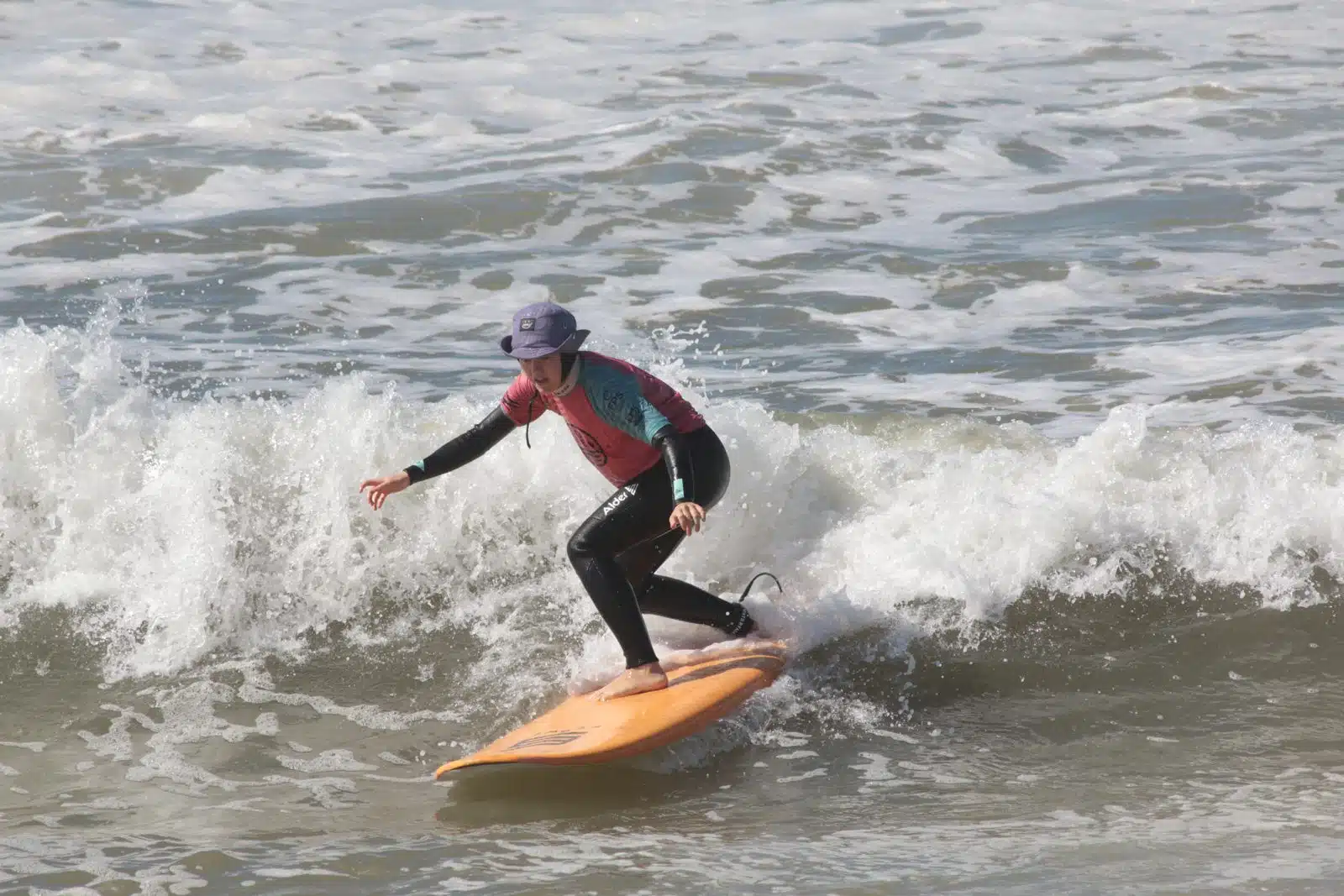 Intermediate surfer riding a green wave during a coached session near Ericeira