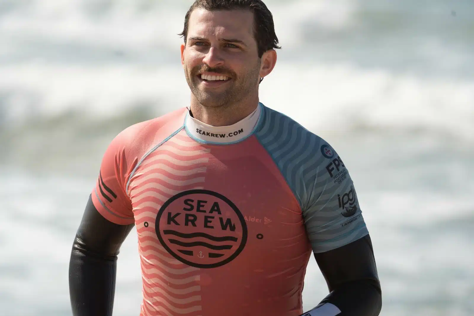 Beginner surfer smiling after his first surf lesson on the Ericeira coast