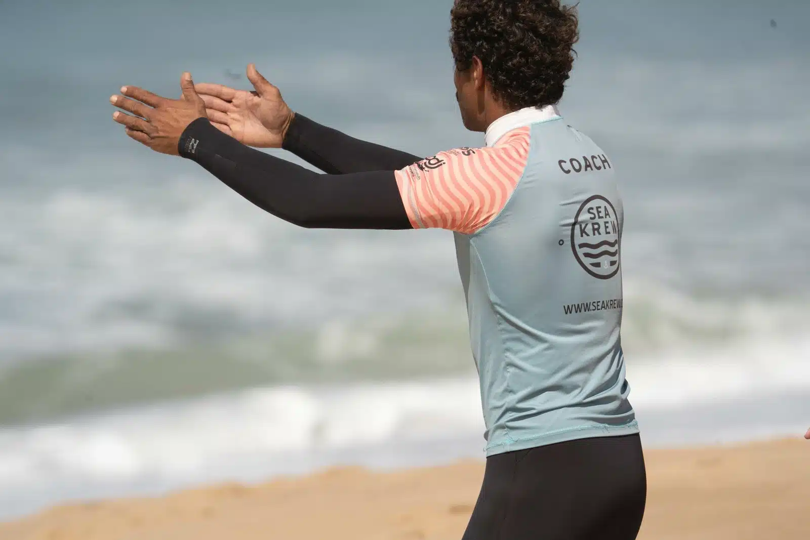 Sea Krew surf coach giving feedback on the beach in Ericeira